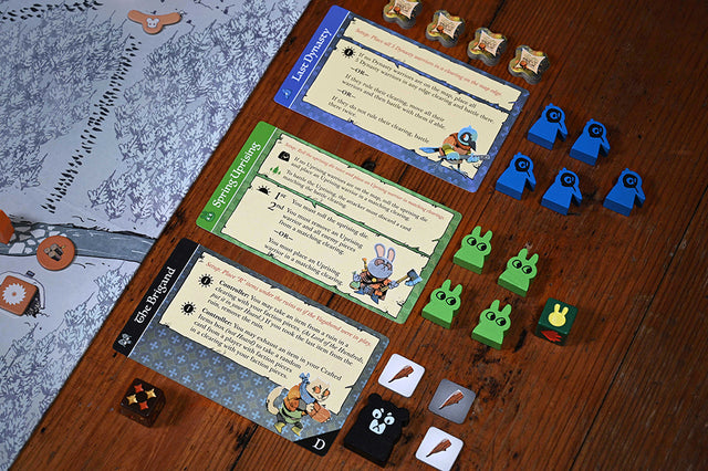 Root hireling meeples and cards next to game board