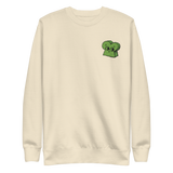 Cream crewneck sweatshirt with the Woodland Alliance meeple embroidered on the left chest. 