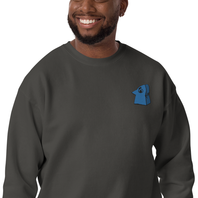 Model wearing a Grey crewneck sweatshirt with the Eyrie meeple embroidered on the left chest.