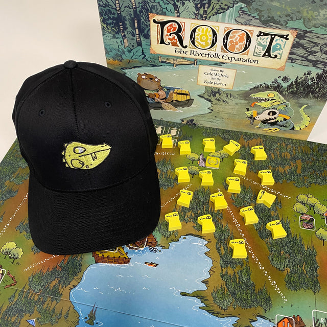 Our Lizard Cult cap, featuring the Lizard's VP marker embroidery, next to the Riverfolk expansion and meeples