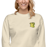 Model wearing a Cream crewneck sweatshirt with the Lizard Cult meeple embroidered on the left chest.