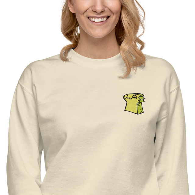 Model wearing a Cream crewneck sweatshirt with the Lizard Cult meeple embroidered on the left chest.