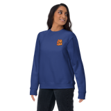 A model wearing a Blue crewneck sweatshirt with the Marquise de Cat meeple embroidered on the left chest.Product mockup