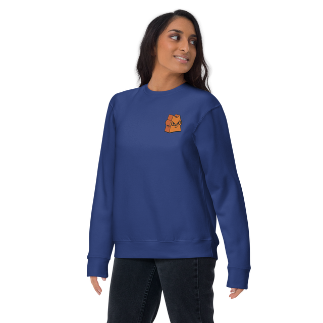 A model wearing a Blue crewneck sweatshirt with the Marquise de Cat meeple embroidered on the left chest.Product mockup