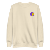 A bone white crewneck sweatshirt with the Chancellor Mask from Oath embroidered on the left chest.