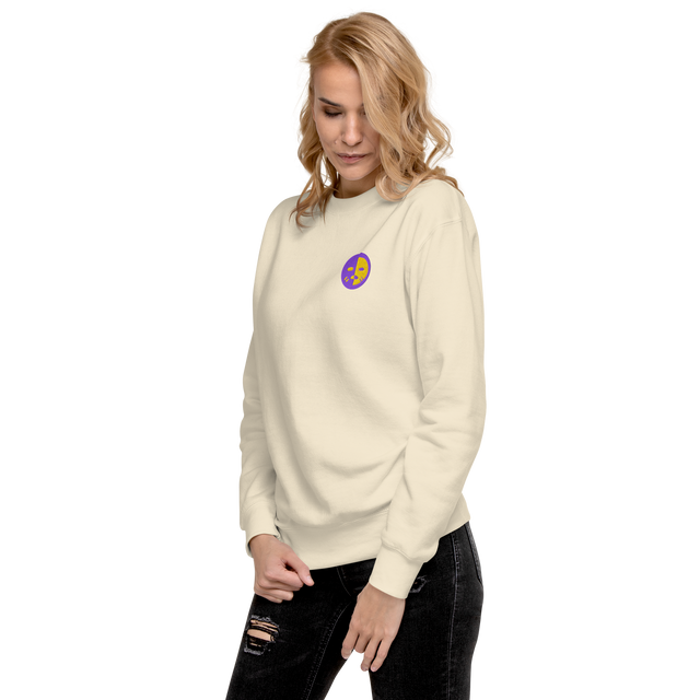 A model wearing a bone white crewneck sweatshirt with the Chancellor Mask from Oath embroidered on the left chest.