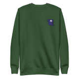 A green crewneck with the Corvid Conspiracy meeple embroidered on the left chest.