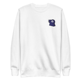 A white crewneck with the Corvid Conspiracy meeple embroidered on the left chest.