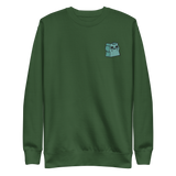 Green crewneck sweatshirt with the Riverfolk Otter meeple embroidered on the left chest. 