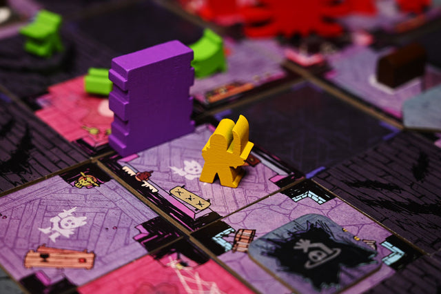 The yellow paladin wooden meeple in play on the Vast the Mysterious Manor board