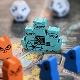 The Riverfolk Flotilla hireling meeple in-play on the Root autumn board